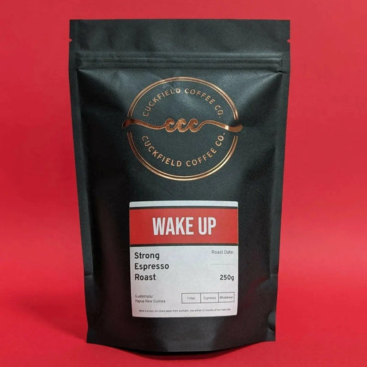 Cuckfield Coffee Co. Wake Up Strong Espresso Roast coffee in a bag with dark roasted beans and a rich aroma.