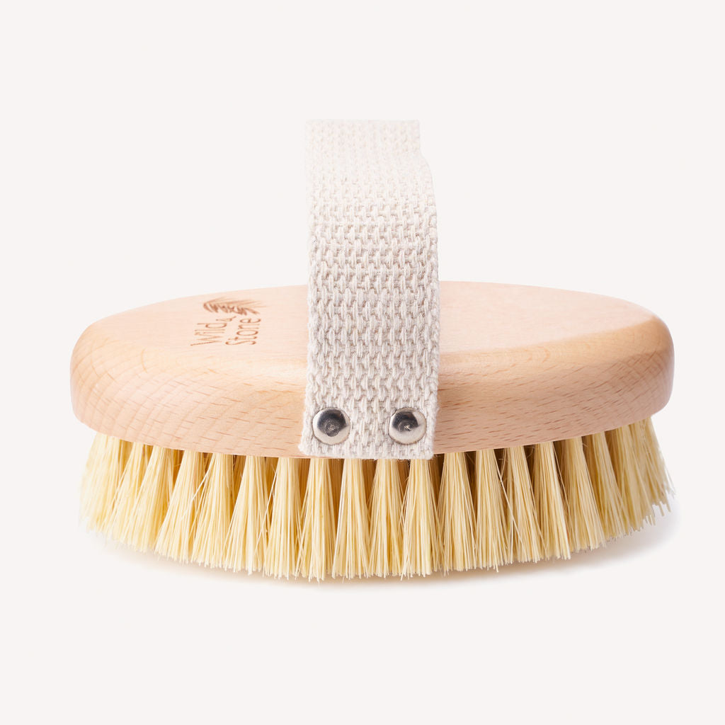 Wild and Stone natural bristle dry body brush with wooden handle for exfoliating and invigorating skin care.