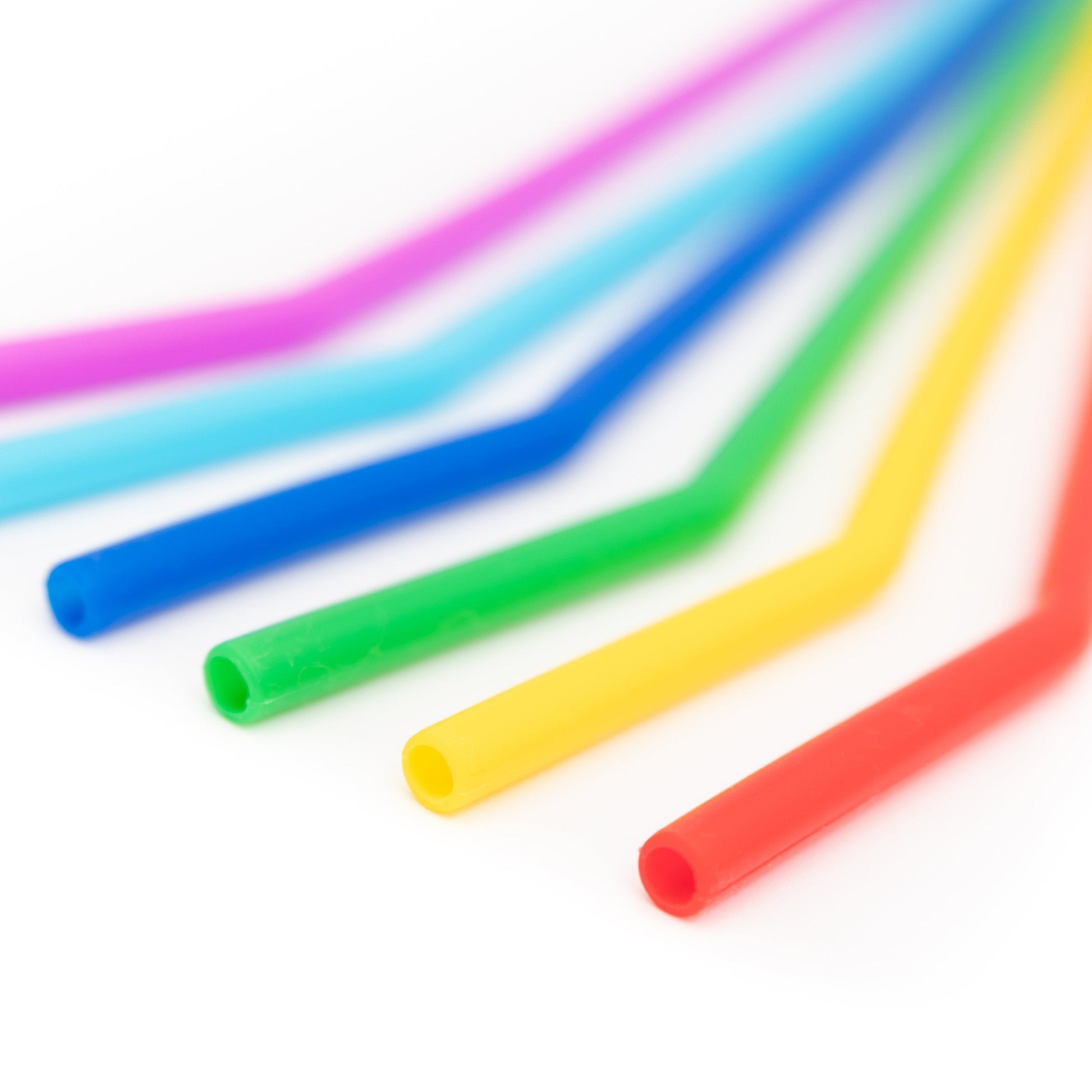 Six reusable silicone drinking straws in a variety of colors, designed for eco-friendly use, by Wild And Stone.