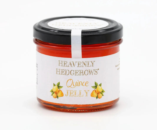 Heavenly Hedgerows Quince Jelly condiment for cheese on a rustic wooden board with cheese and crackers.