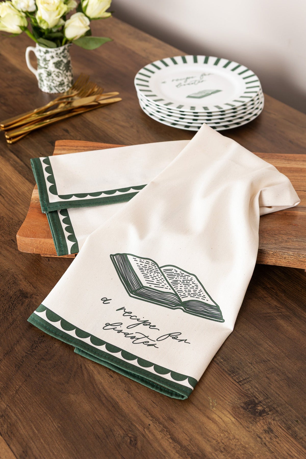 Bone china plate featuring a Recipe For Disaster design by Avalon Home UK, shown on a table with a colorful patterned cloth.