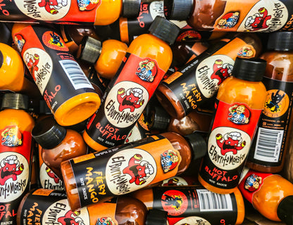 El Burrito Monster Hot Buffalo Sauce bottle from Lou's Brews, featuring vibrant label design and spicy sauce inside.