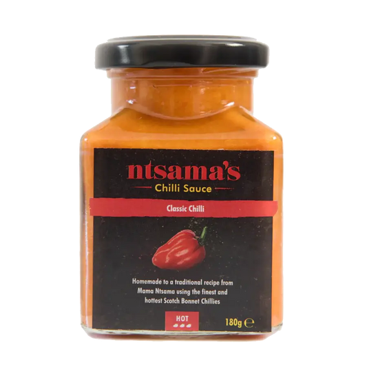 Bottle of ntsama.co.uk Classic Sauce with label visible, showcasing the rich, smooth sauce in a clear glass bottle.