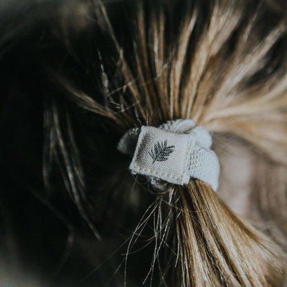 Set of six black plastic-free hair ties by Wild And Stone, natural elastic hair accessories for gentle, eco-friendly styling.