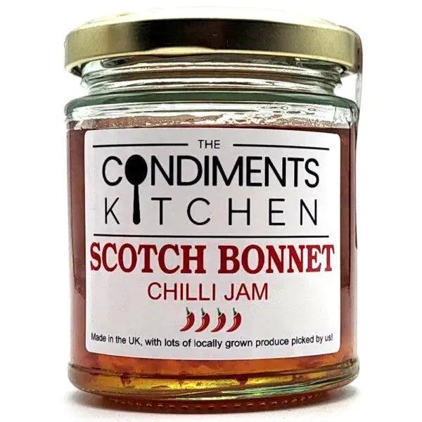Jar of Scotch Bonnet Chilli Jam by The Condiments Kitchen showing vibrant red chili jam in a glass jar.