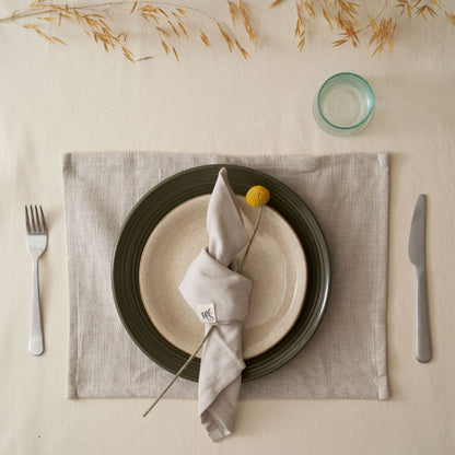 Set of four organic cotton napkins by Wild And Stone, showcasing soft, eco-friendly fabric with elegant stitching.