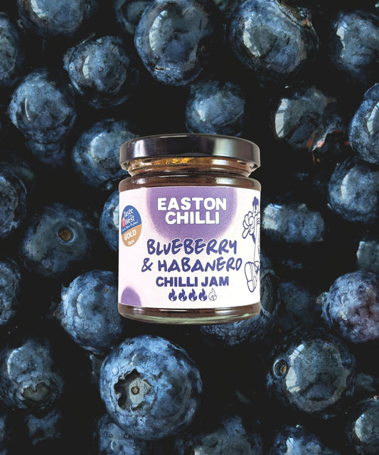 Easton Chilli Blueberry & Habanero Chilli Jam jar with vibrant label and fresh blueberries and habanero peppers.