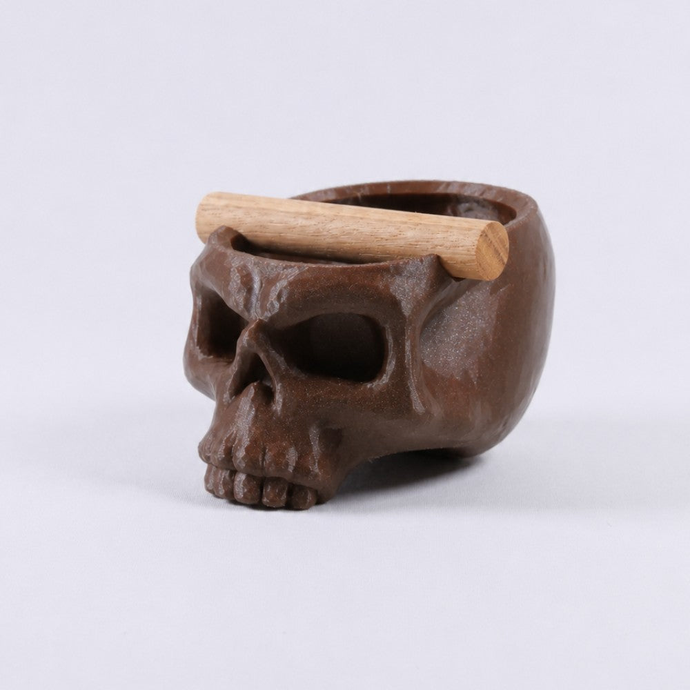 Gothic skull espresso knock box with oak bar by KNOCDIC®, featuring a galaxy brown finish and skull-shaped design for coffee enthusiasts.