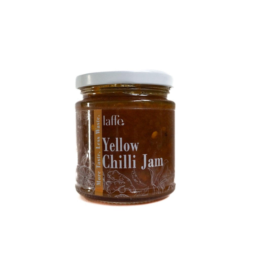 Laffe sustainable yellow chilli jam in a jar, showcasing vibrant yellow chilli sauce with fresh chili peppers around it.