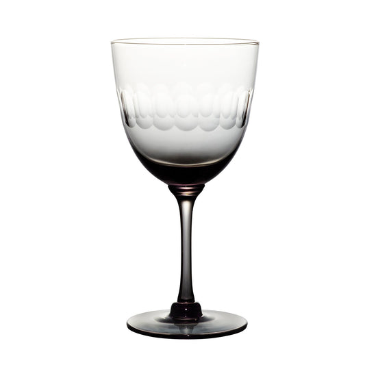 four smoky crystal wine glasses with lens design
