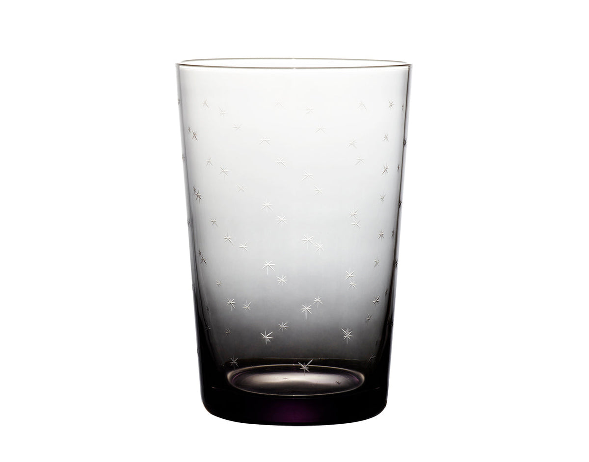 Four smoky crystal tumblers with star designs from The Vintage List, showcasing their elegant, starry glassware for serving beverages.