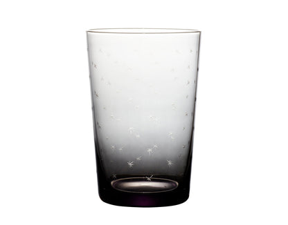Four smoky crystal tumblers with star designs from The Vintage List, showcasing their elegant, starry glassware for serving beverages.