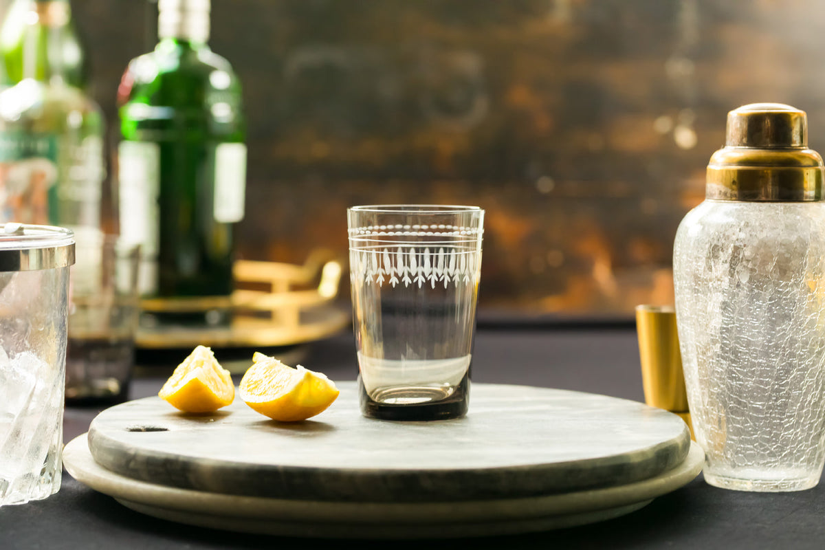 Four smoky crystal tumblers with oval design from The Vintage List, showcasing their elegant, translucent glass appearance.