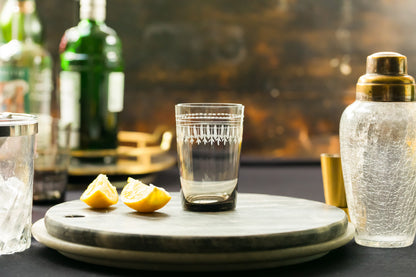 Four smoky crystal tumblers with oval design from The Vintage List, showcasing their elegant, translucent glass appearance.