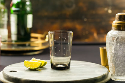 Four smoky crystal tumblers with star designs from The Vintage List, showing their transparent glass and star patterns.