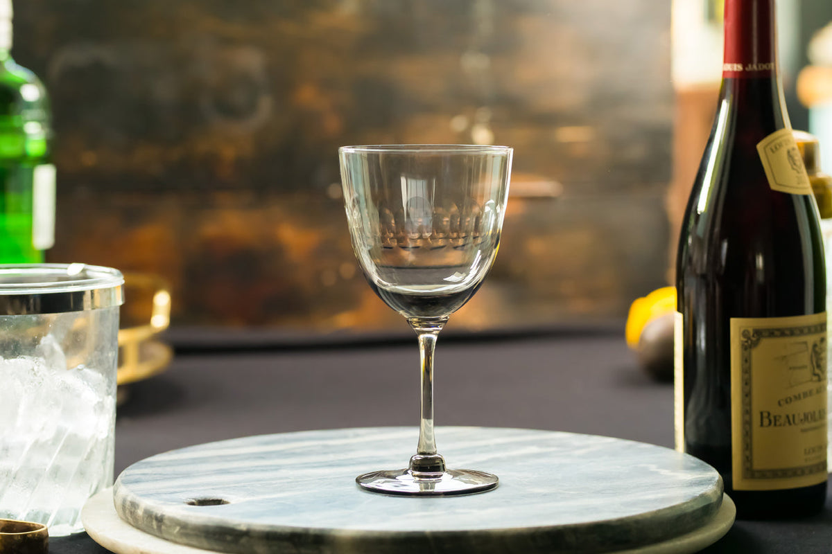 Four smoky crystal wine glasses with lens design from The Vintage List, showcasing elegant, tinted glassware for wine enjoyment.