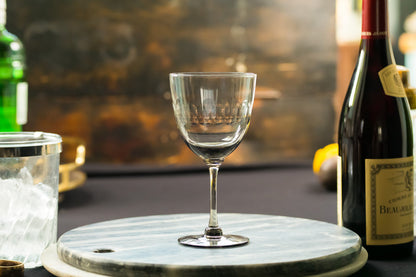 Four smoky crystal wine glasses with lens design from The Vintage List, showcasing elegant, tinted glassware for wine enjoyment.