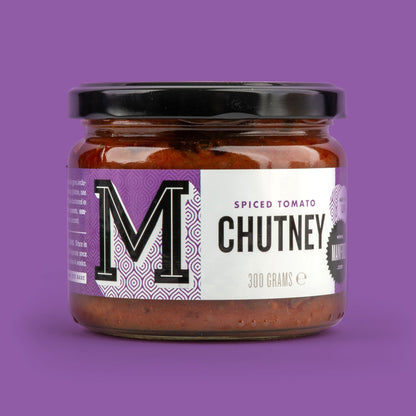 Manfood Spiced Tomato Chutney jar with vibrant reddish-orange chutney visible inside, showcasing the flavorful condiment.