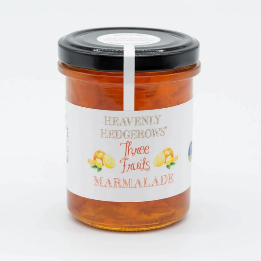 Three Fruit Marmalade by Heavenly Hedgerows featuring a jar of vibrant, chunky marmalade made with a blend of fresh fruits.