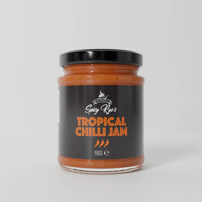 Spicy Ryes Tropical Chilli Jam jar with vibrant tropical fruit and chili ingredients visible inside, showcasing the colorful spread.