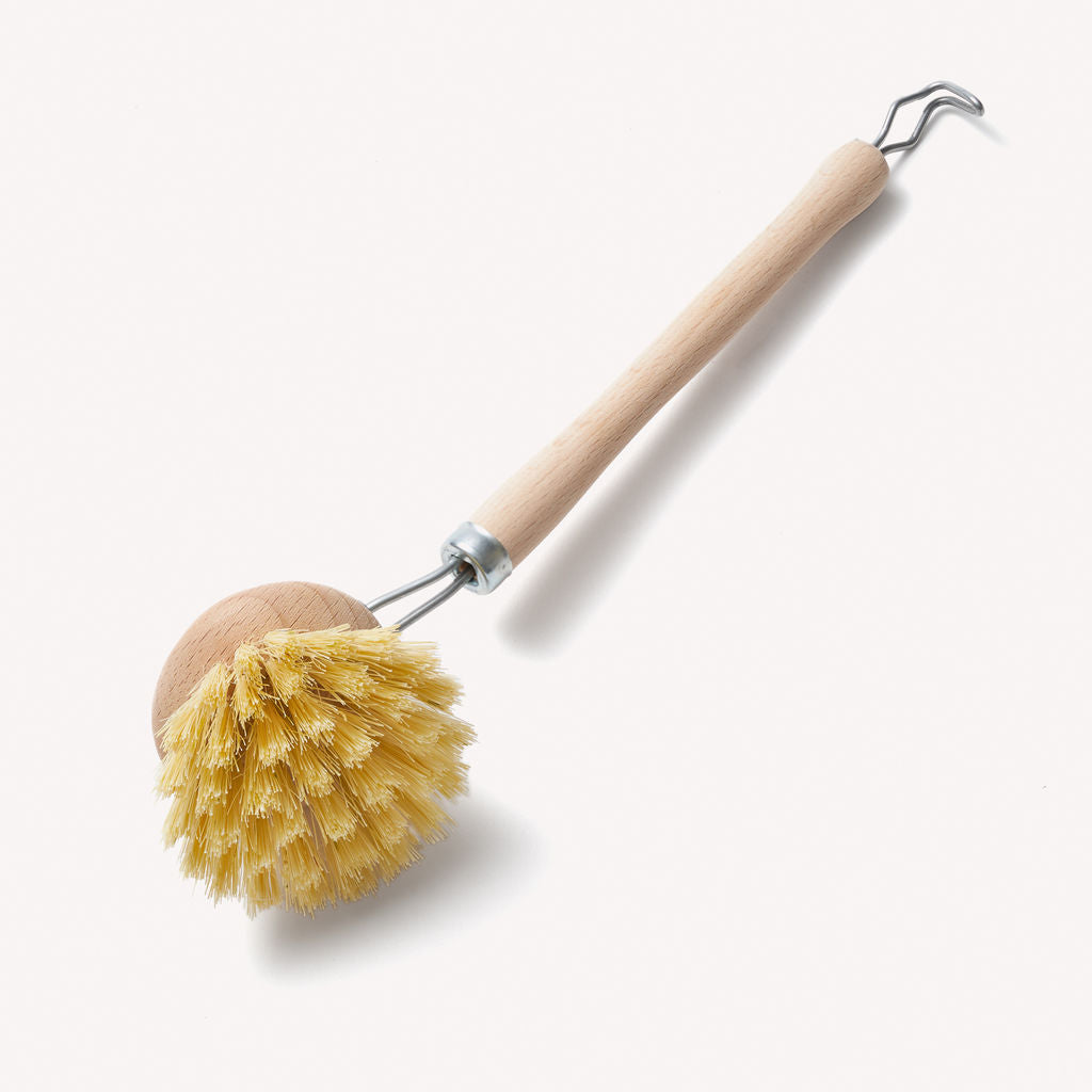 Wooden dish brush by Wild And Stone with a replaceable head for eco-friendly kitchen cleaning.