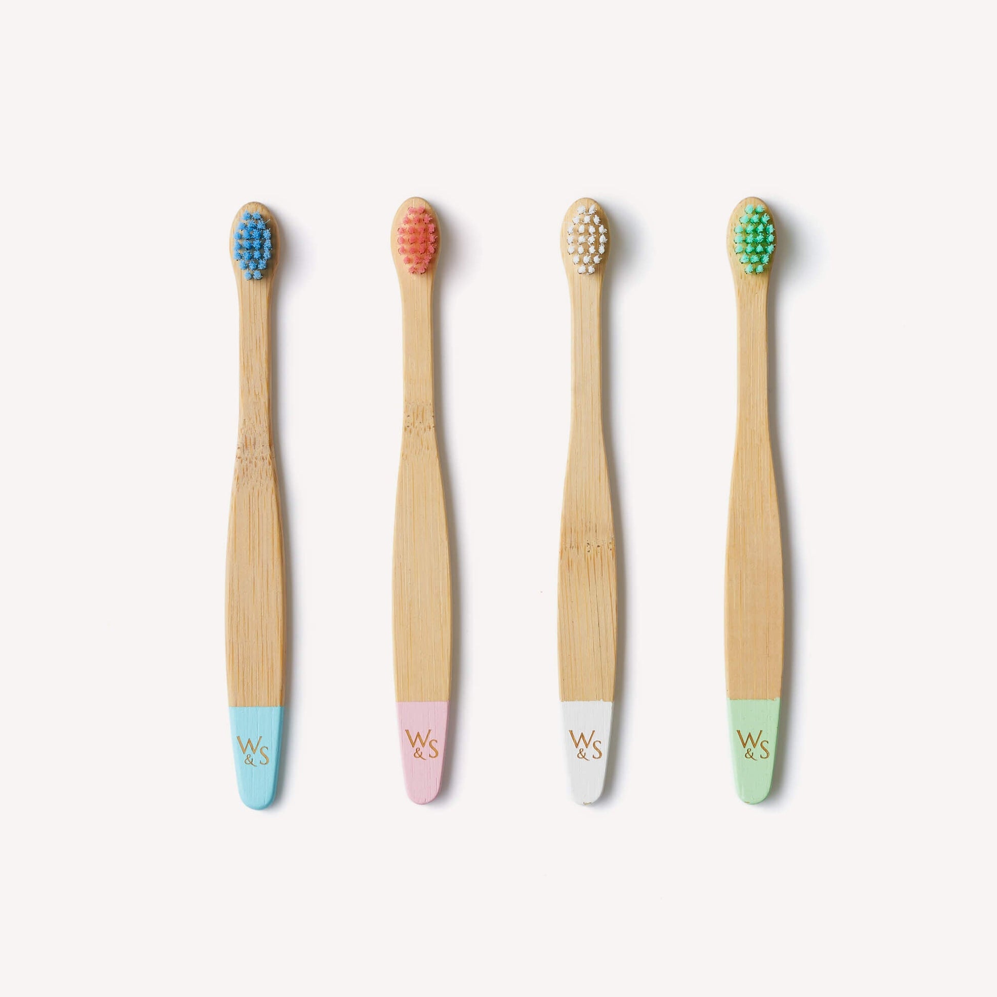 Baby bamboo toothbrush with extra soft bristles from Wild And Stone, shown in a 4-pack, suitable for gentle cleaning.