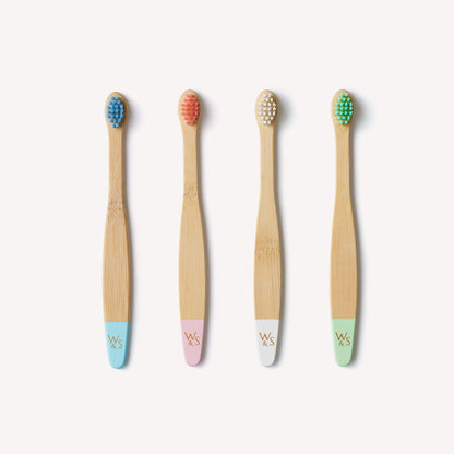 Baby bamboo toothbrush with extra soft bristles from Wild And Stone, shown in a 4-pack, suitable for gentle cleaning.