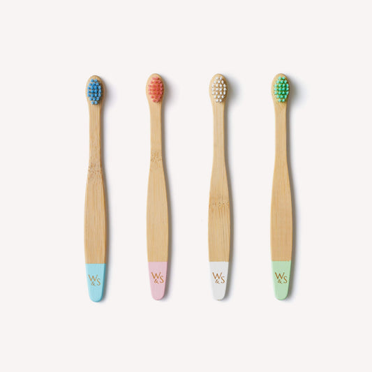 Baby bamboo toothbrush with extra soft bristles from Wild And Stone, shown in a 4-pack, suitable for gentle cleaning.