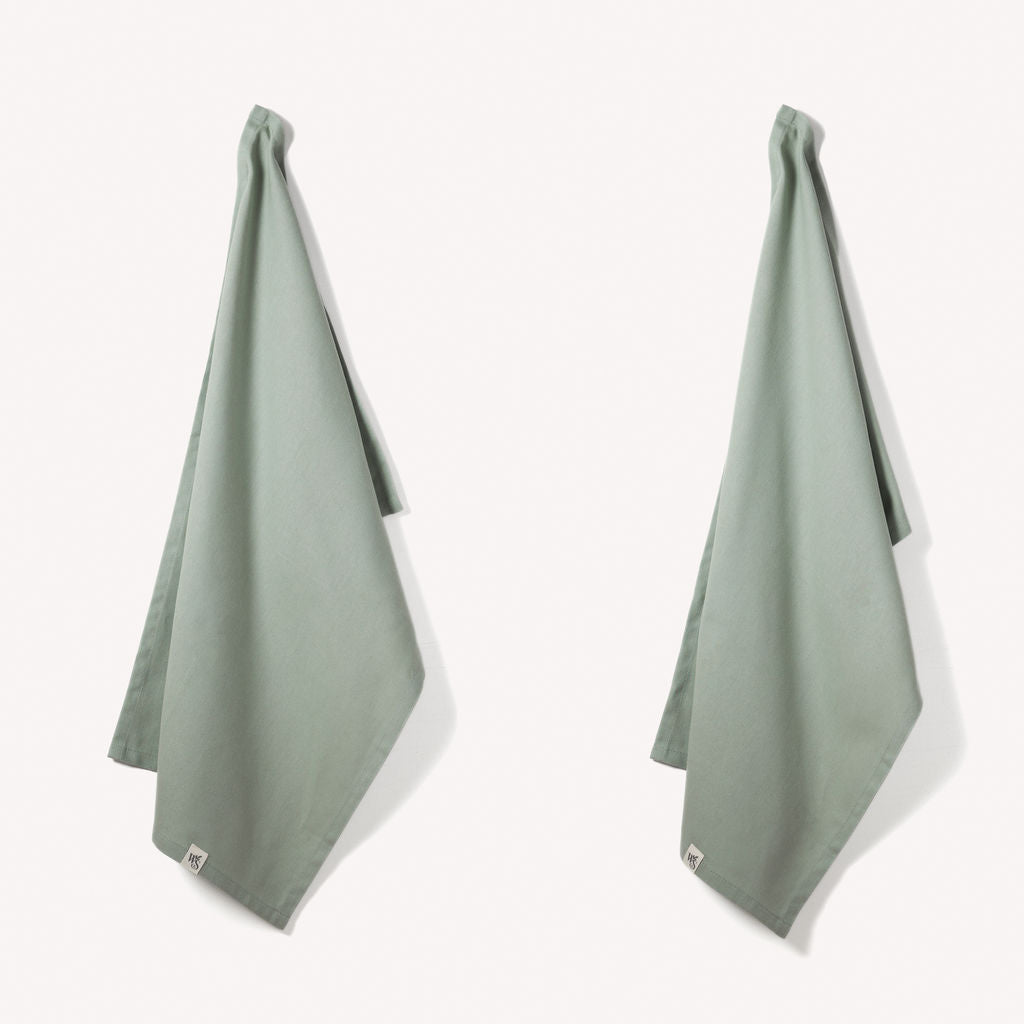 Set of two Wild and Stone organic cotton tea towels with herringbone weave, perfect for kitchen use and drying dishes.