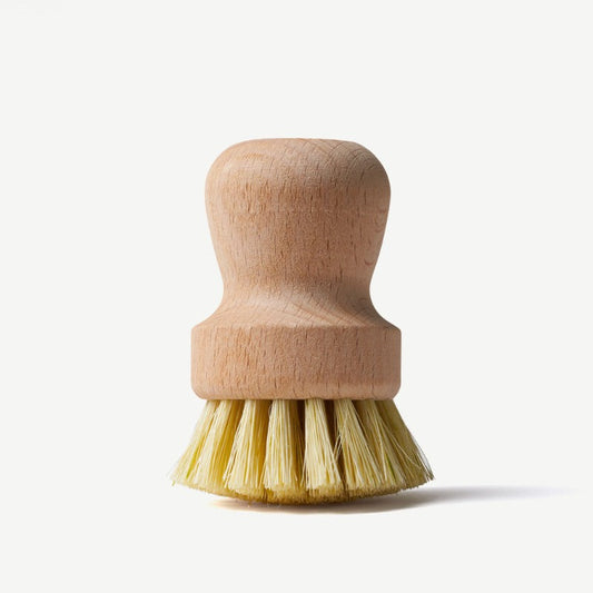 Wild And Stone wooden dish brush with natural wooden handle and bristles, designed for cleaning pots and dishes.