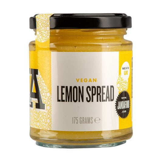 Vegan Lemon Curd by Manfood showing a jar of artisan lemon spread with fresh lemons and a spoon on a rustic wooden surface.