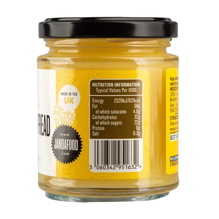 Vegan Lemon Curd spread by Manfood, featuring a jar of vibrant lemon spread with fresh lemon slices on a rustic wooden surface.