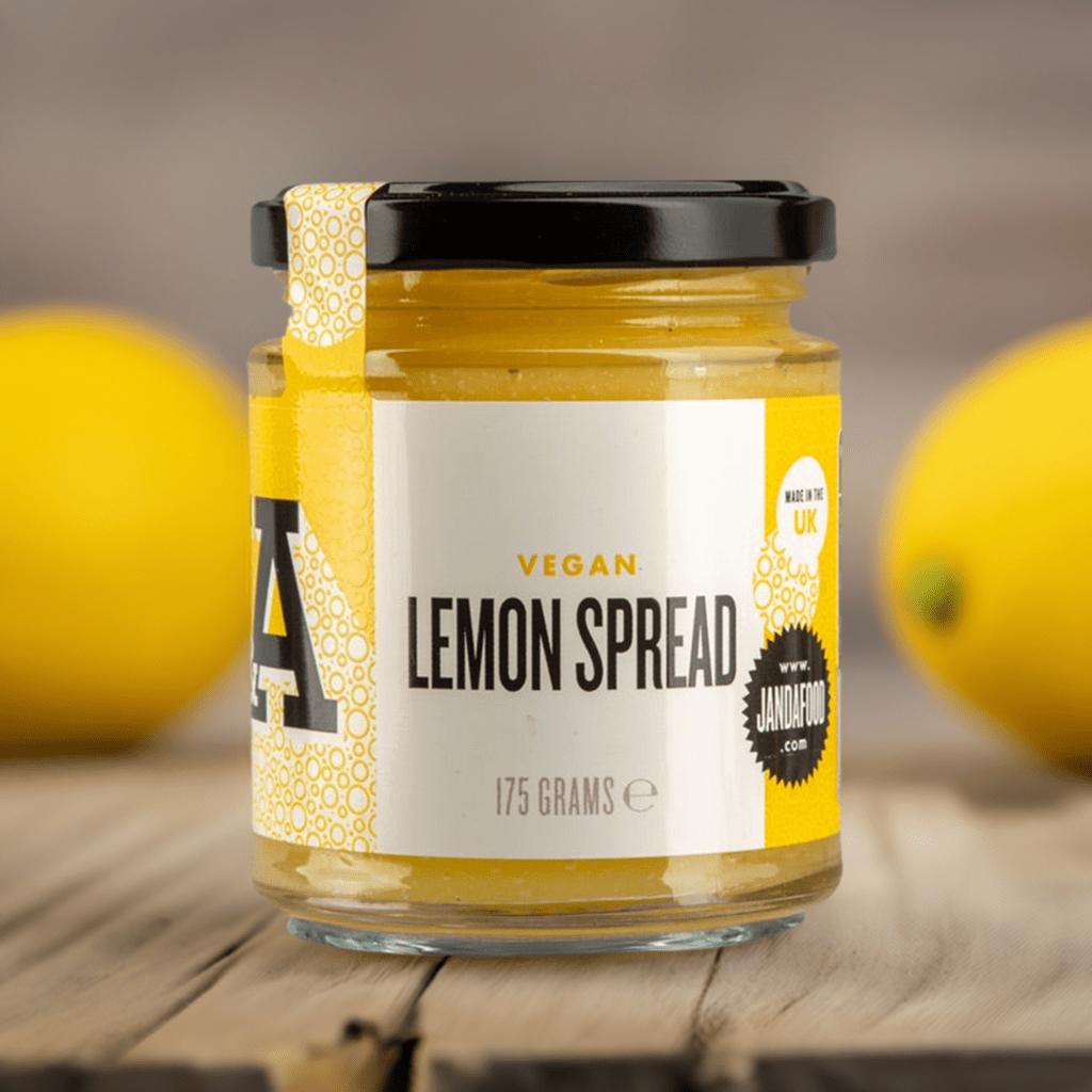 Janda vegan lemon spread jar with lemon slices and spread texture close-up, showcasing fresh, tangy citrus flavor.