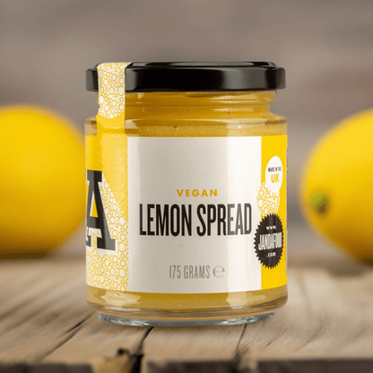 Janda vegan lemon spread jar with lemon slices and spread texture close-up, showcasing fresh, tangy citrus flavor.