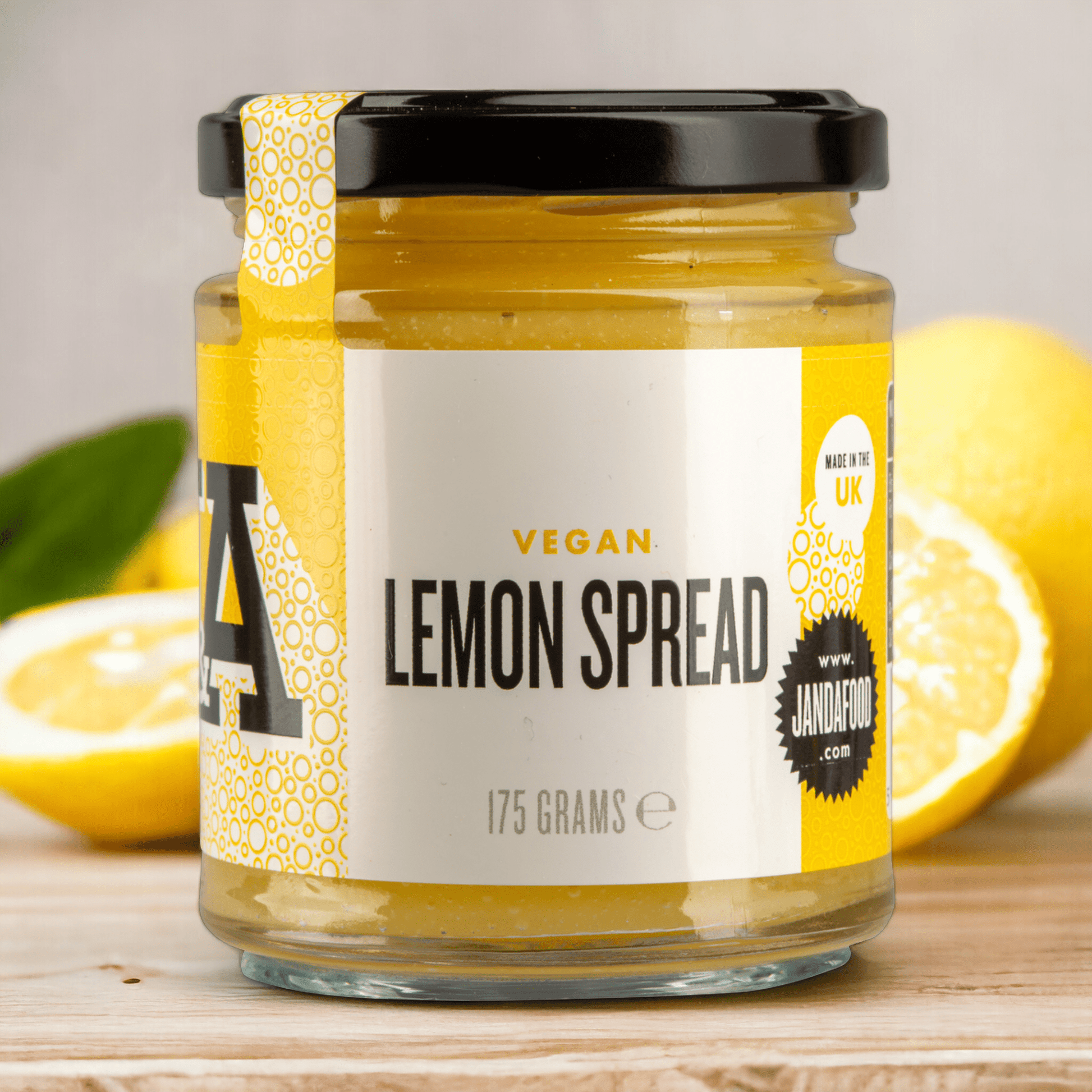 Janda vegan lemon spread in a jar, showcasing a vibrant yellow citrus spread with fresh lemon zest and natural texture.