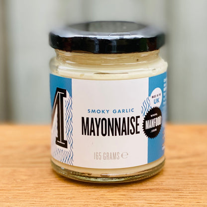 Creamy vegan smoky garlic mayonnaise from Manfood, featuring a smooth texture and rich garlic flavor in a jar.