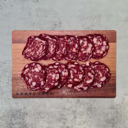 Sliced venison salami on a charcuterie board, featuring Bray Cured's personal slicing salami, perfect for gourmet charcuterie displays.