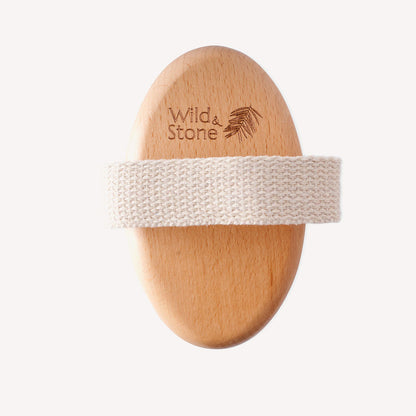 Natural bristle dry body brush by Wild and Stone, showing the textured wooden handle and soft bristles for exfoliating skincare.