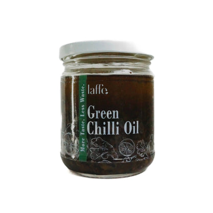 Green chilli oil in a clear glass bottle from Laffe, showcasing vibrant green chillies infused in chili oil on a white background.