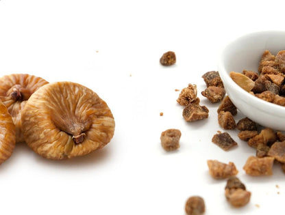 Chopped dried figs by Whole Food Earth, GMO-free, vegan, dairy-free, with no added sugar in a clear container.
