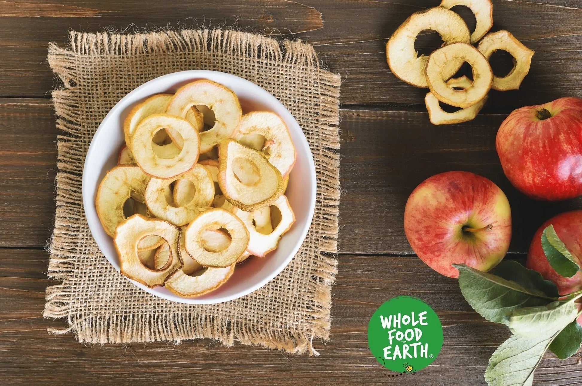 Organic dried apple rings from Whole Food Earth, showing golden, sliced apple snacks on a white background.