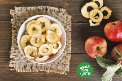 Organic dried apple rings from Whole Food Earth, showing golden, sliced apple snacks on a white background.