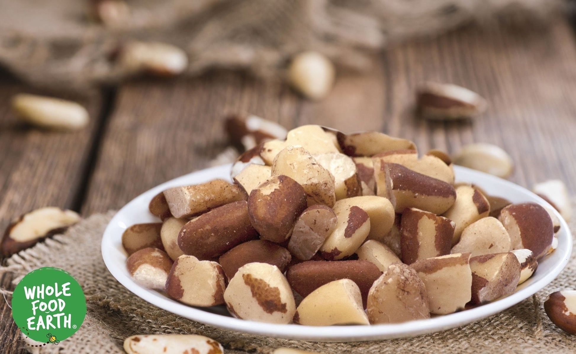 Raw organic broken Brazil nuts from Whole Food Earth, showing their natural, textured appearance in a close-up image.