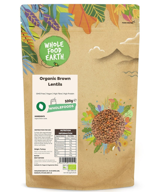 Whole organic brown lentils from ArtisanBox, GMO-free, displayed in a clear bowl with some scattered on a neutral background.