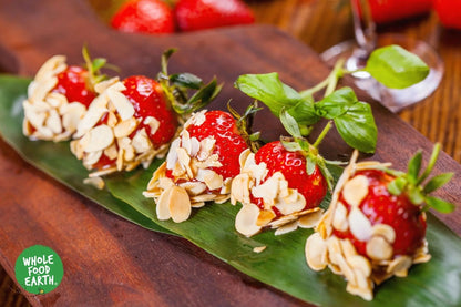 Organic flaked almonds from Whole Food Earth, GMO-free nuts and seeds, showing a close-up of light, crunchy almond flakes.