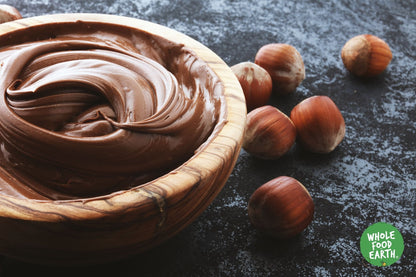 Raw organic hazelnuts from Whole Food Earth, GMO-free nuts and seeds product with whole, natural hazelnuts in a close-up view.