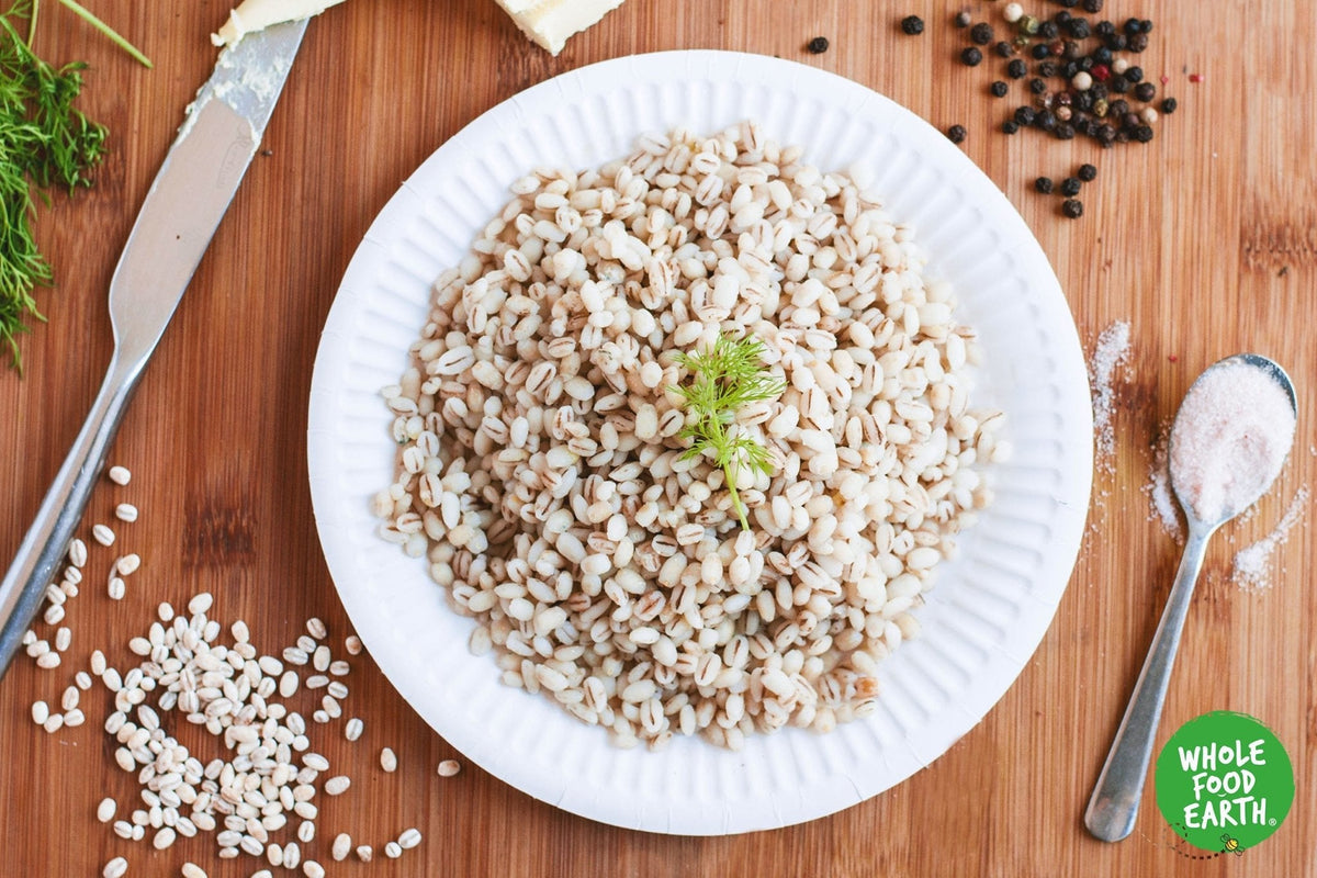 Organic dried pearl barley from Whole Food Earth, showing a close-up of light beige, rounded pearl barley grains in a natural setting.