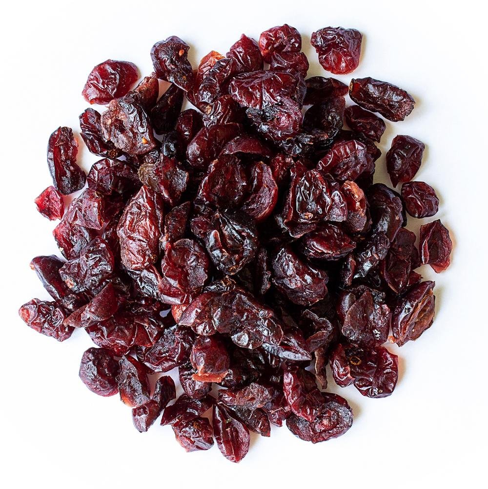 Organic sweetened dried cranberries from Whole Food Earth, GMO-free dried fruits with vibrant red color and textured surface.