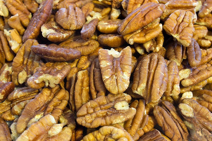Raw Whole Food Earth pecan halves, GMO-free nuts and seeds, showing light brown, crunchy pecans on a white background.