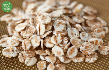 Whole Food Earth wheat flakes cereal in a bowl, GMO-free, vegan, dairy-free, with no added sugar.
